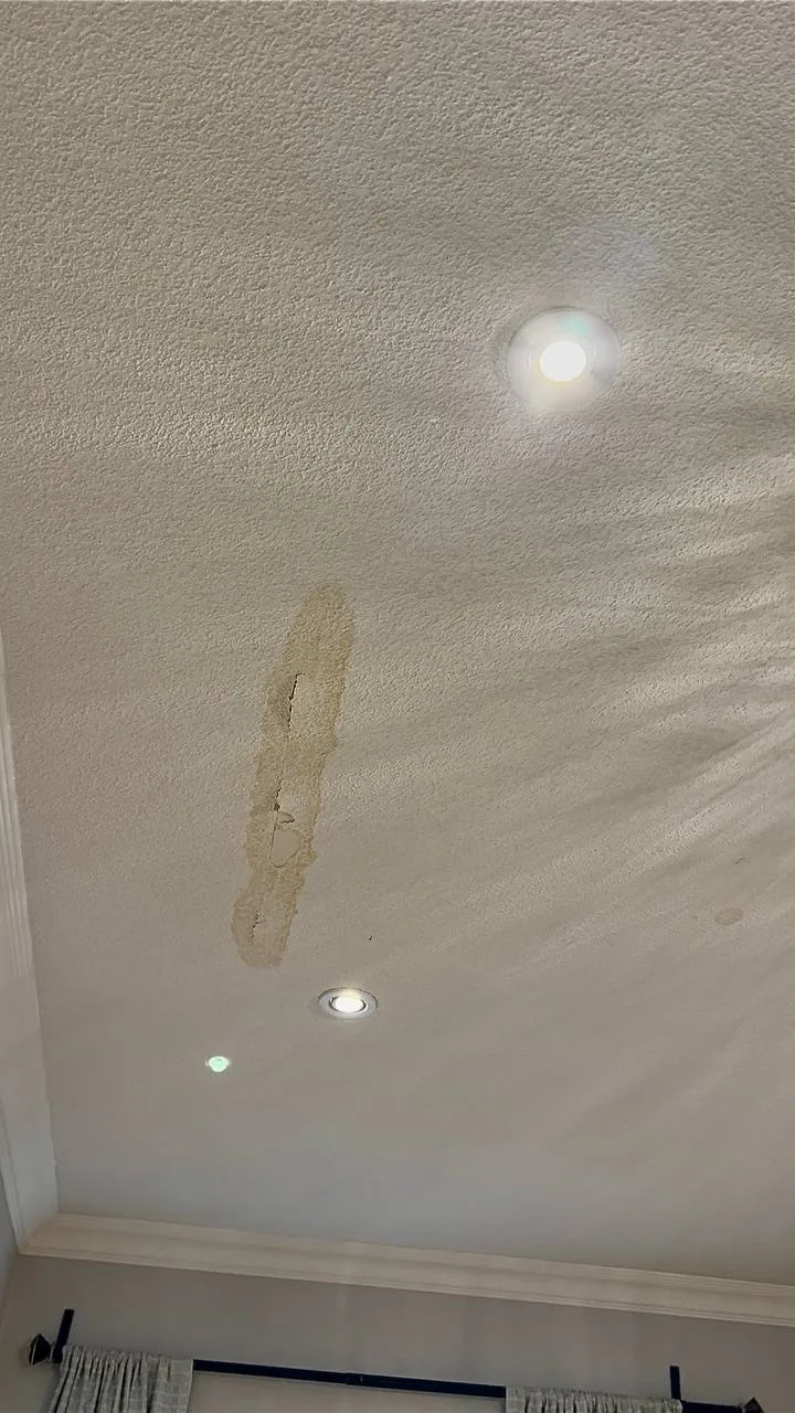Ceiling with a water stain from a leak before repair