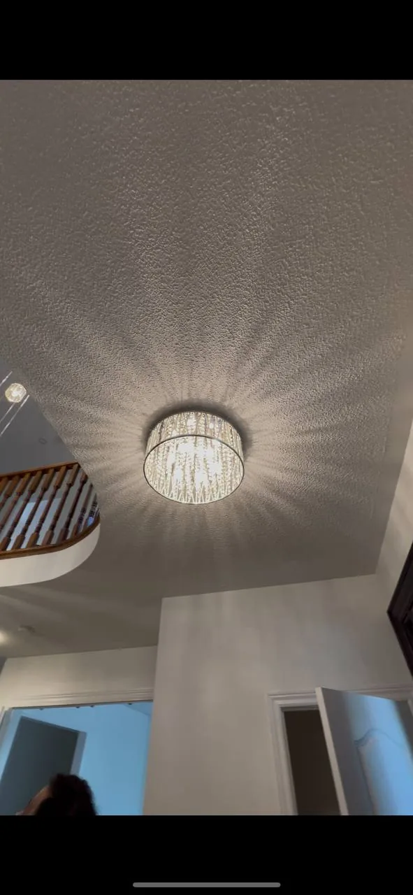 Textured ceiling above a foyer with chandelier before removal
