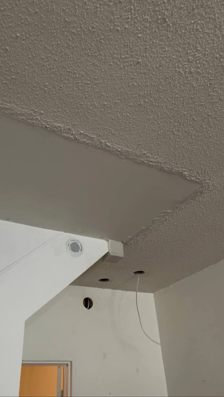 Popcorn texture on a vaulted ceiling corner before removal