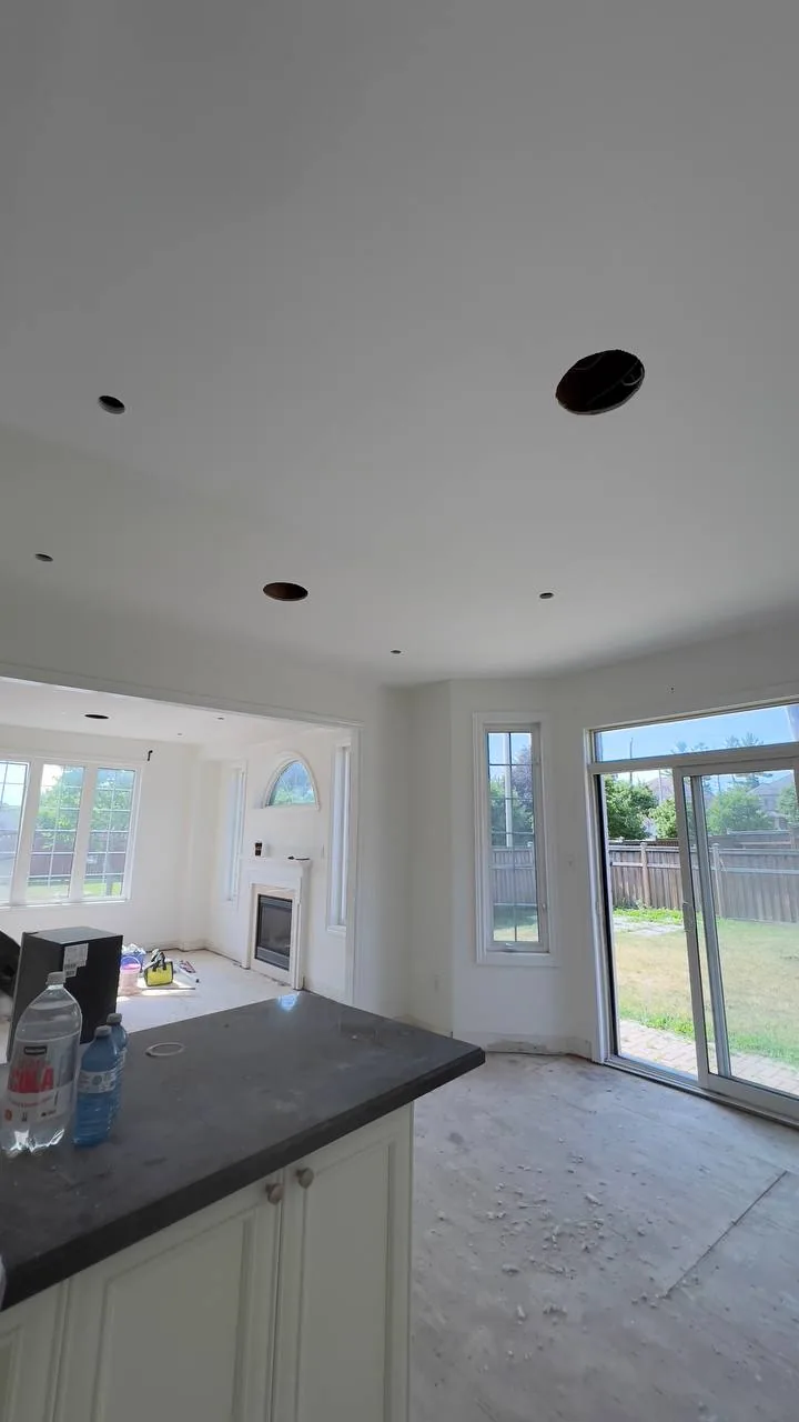 Finished kitchen ceiling with fireplace visible beyond