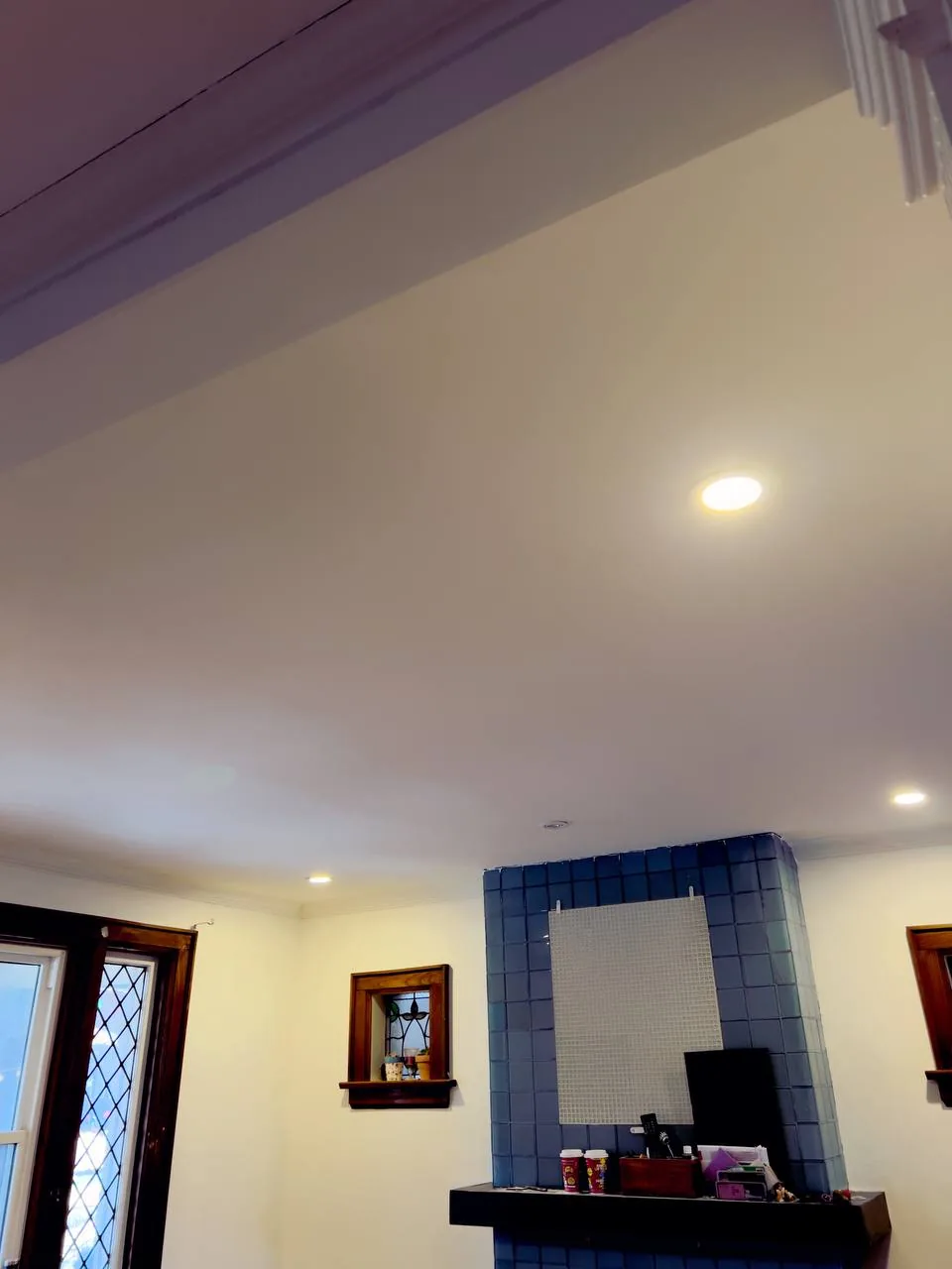 Finished vaulted ceiling above a tiled fireplace