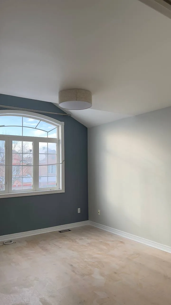 Finished bedroom with a blue accent wall
