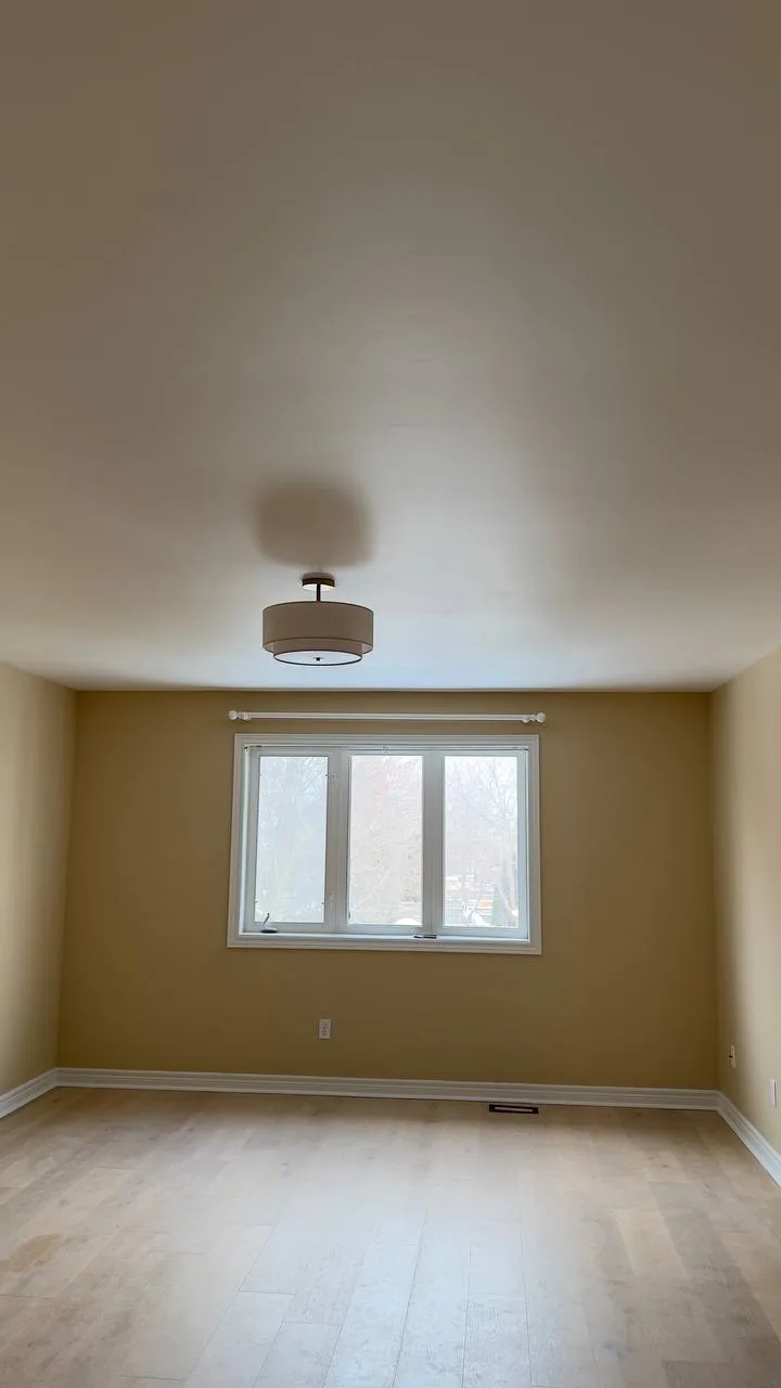 Finished bedroom with a mustard yellow wall