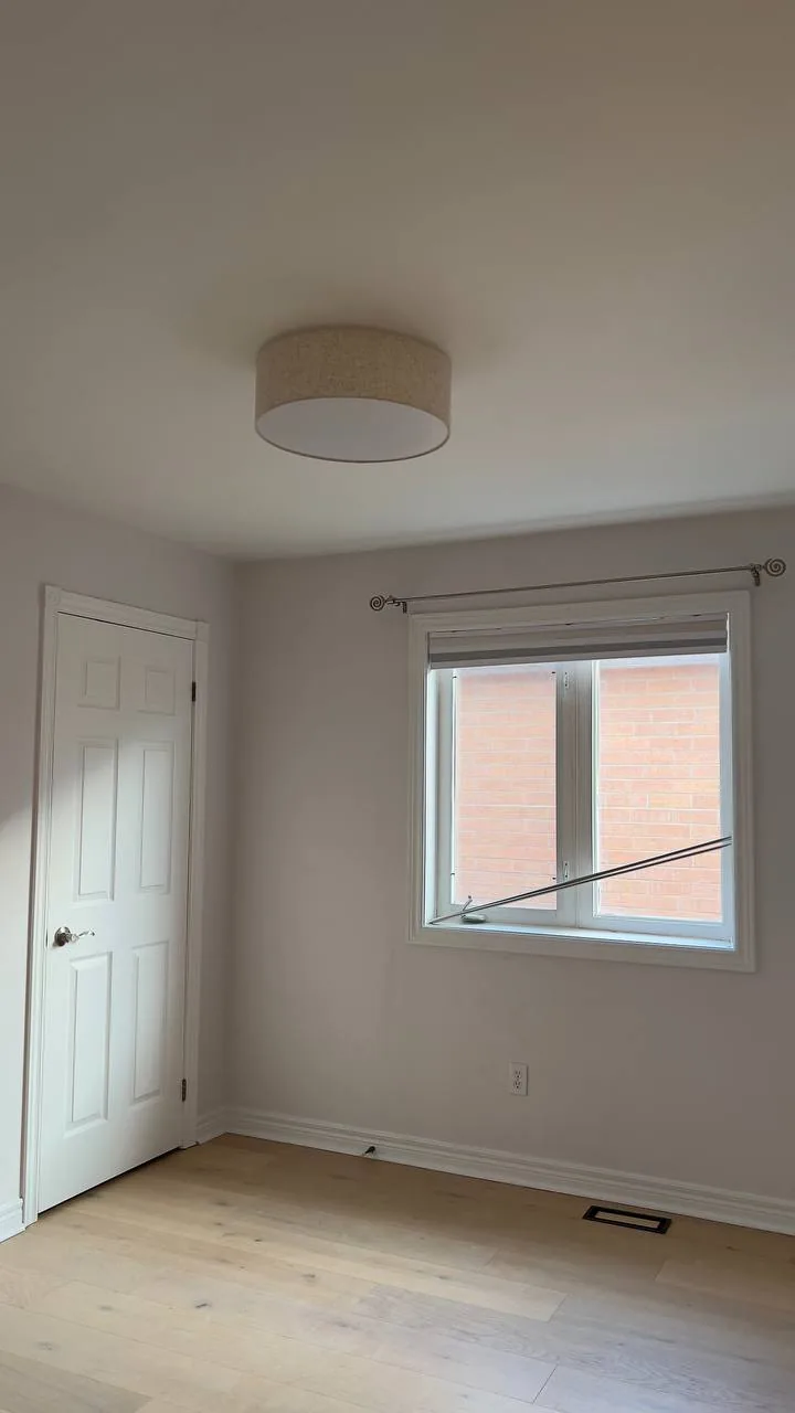 Finished bedroom with white trim and door
