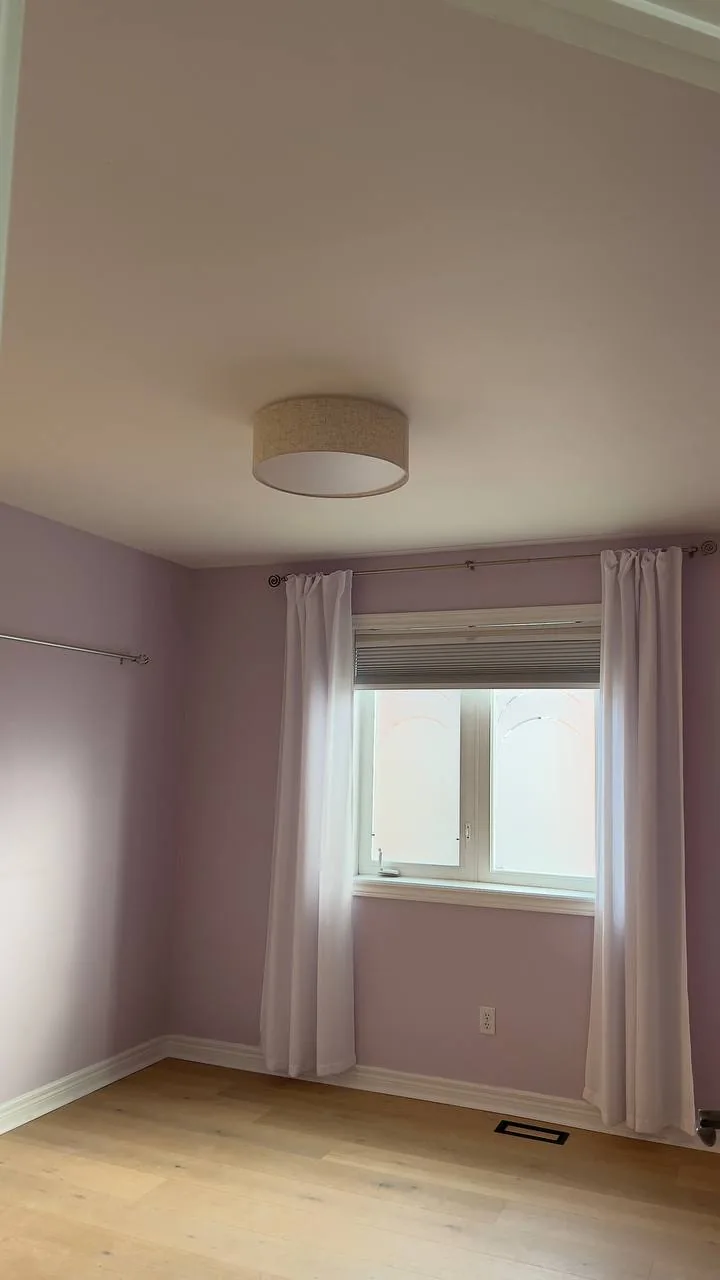 Finished bedroom with lavender walls and curtains