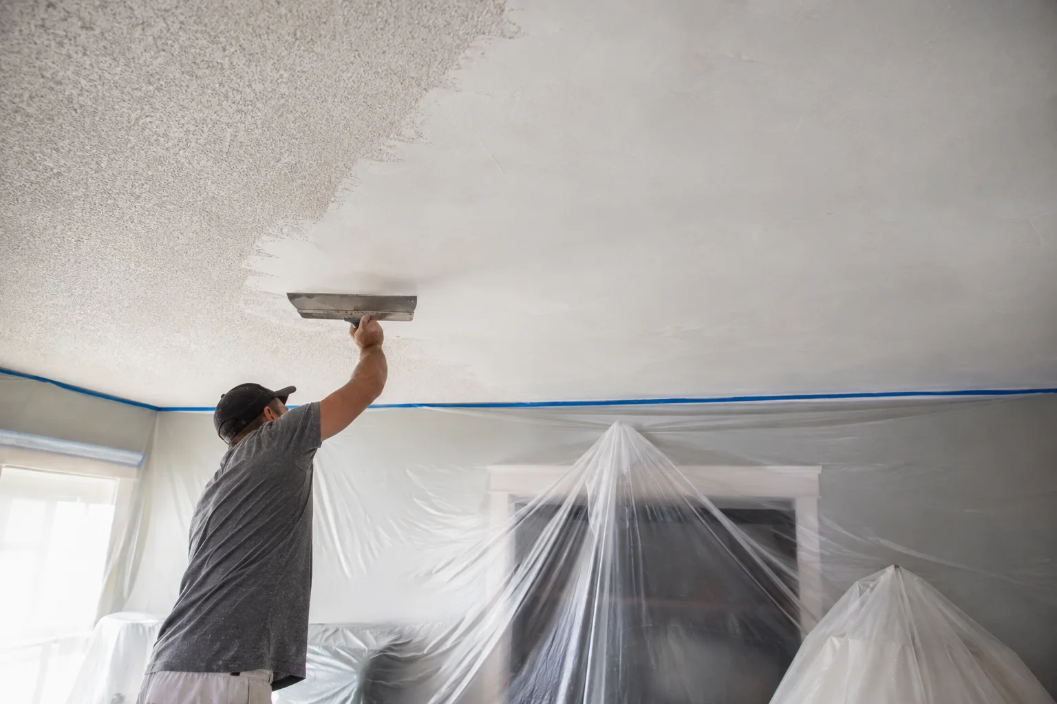 Representative popcorn ceiling removal scene with dust protection